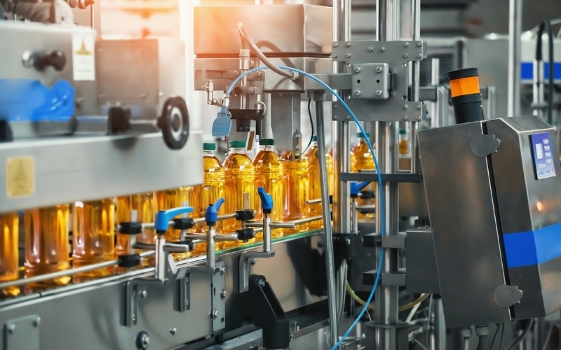 Bottles are being filled along a packaging line.