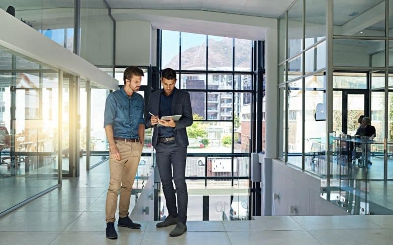 Two men engage in a consultation for contract manufacturing.