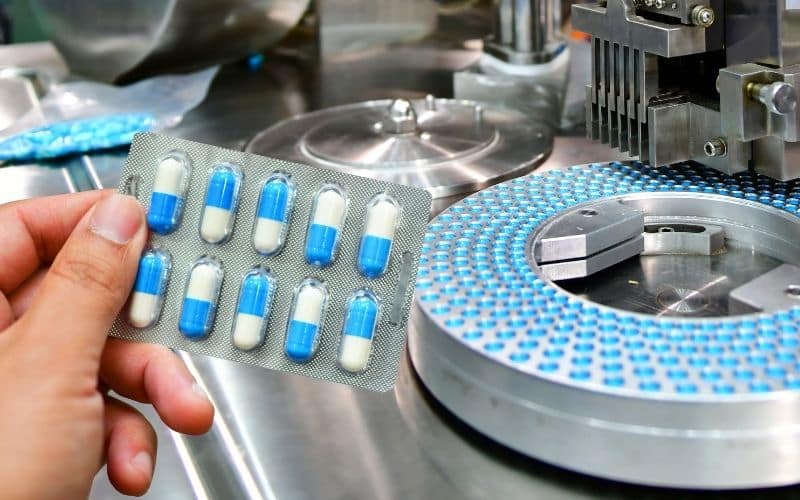 Pills are packaged in blister packs at a contract packaging facility.