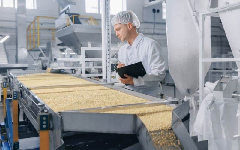A worker inspects product at a contract manufacturing facility.