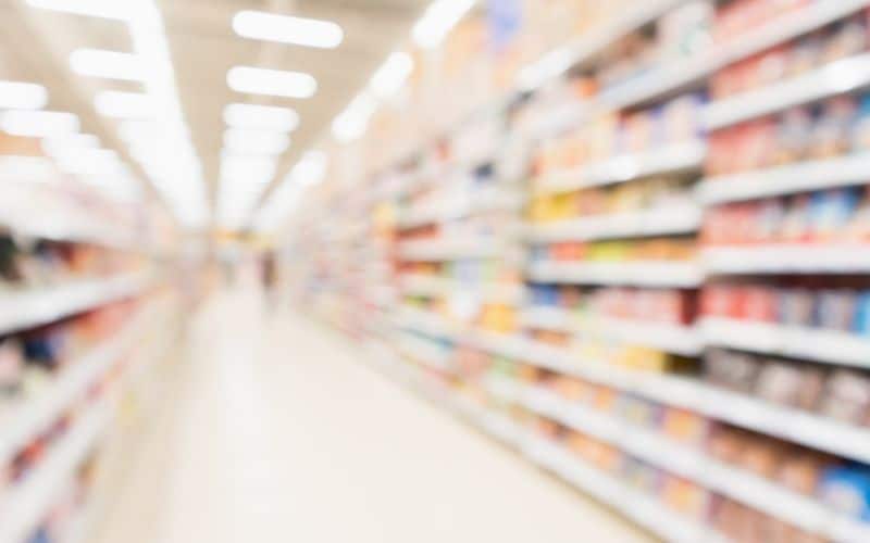 Blurred image of food packaging on a shelf.
