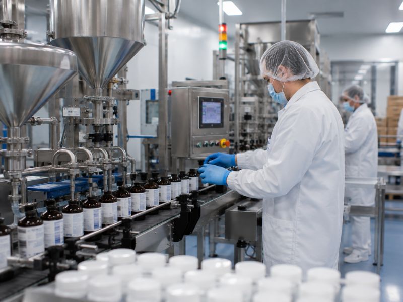 High-speed beverage bottling line with automated filling equipment inside a turnkey contract manufacturing facility.